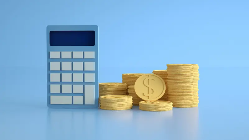 Stacks of gold dollar coins beside a blue calculator