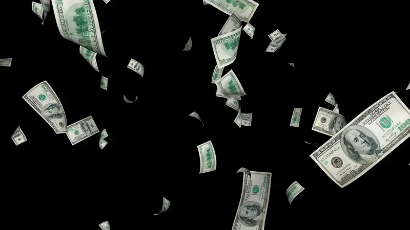 US hundred-dollar bills falling against a black background
